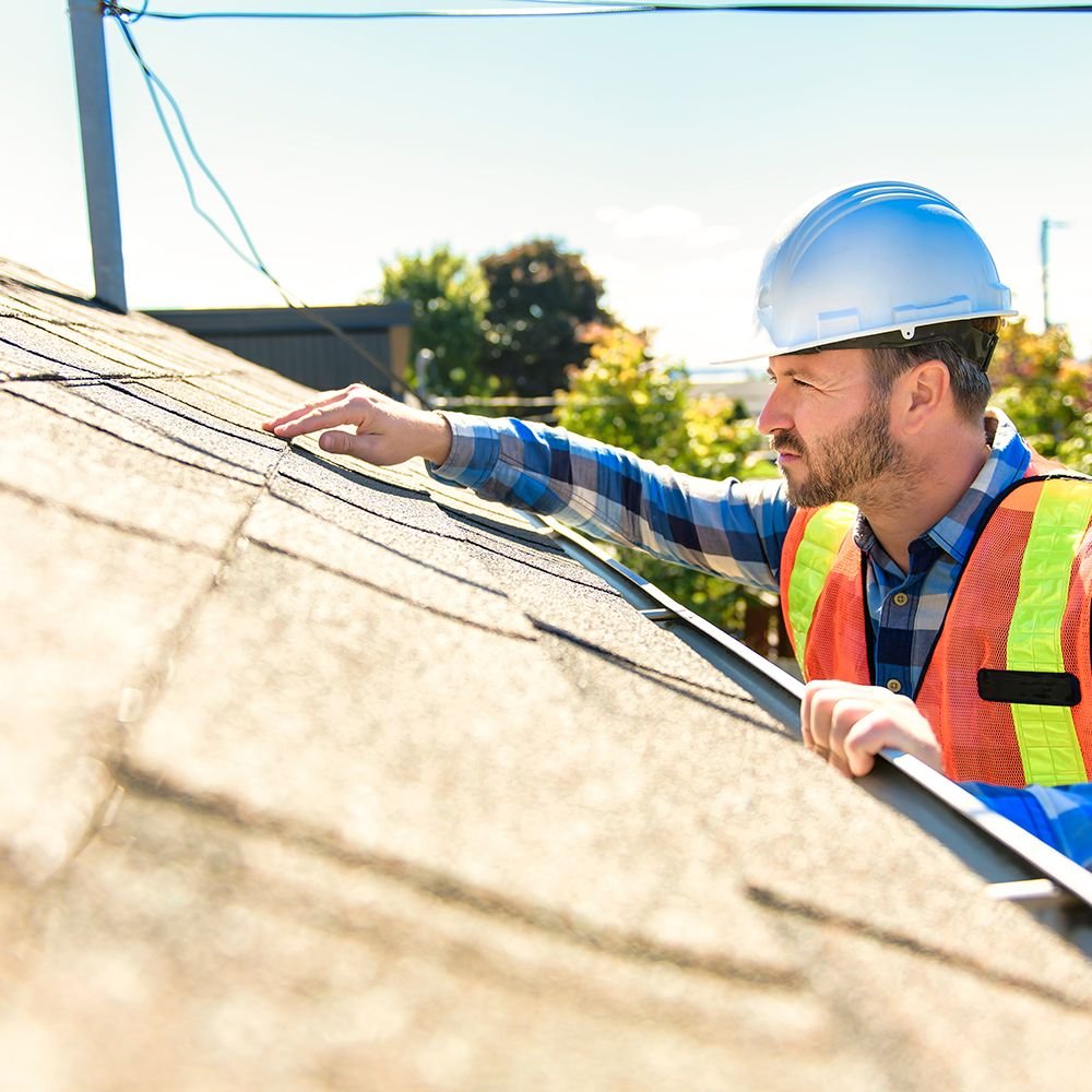 1907 Roofing expert conducting a detailed roof inspection in Oklahoma City, identifying potential issues to ensure roof integrity